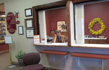 A receptionist is answering calls at the front desk